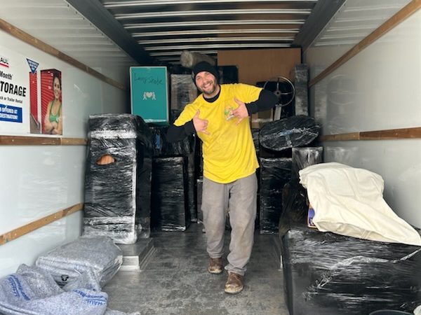A Hercules mover standing in a loaded moving truck