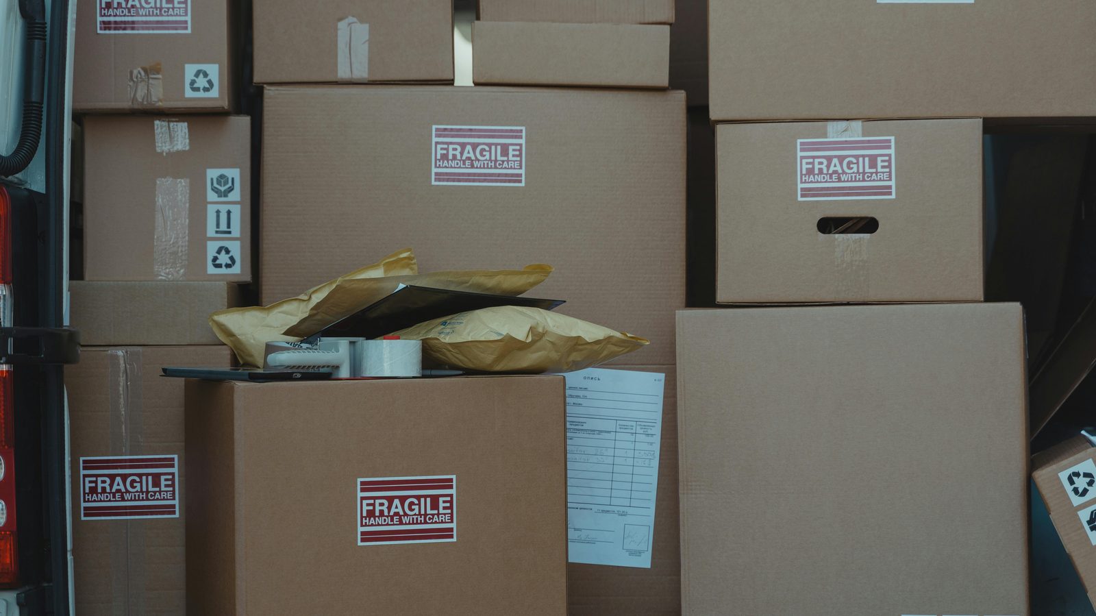 A stack of packed and labeled moving boxes in a customer's living room