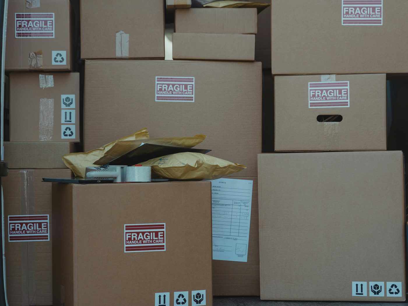 A stack of packed moving boxes with fragile labels