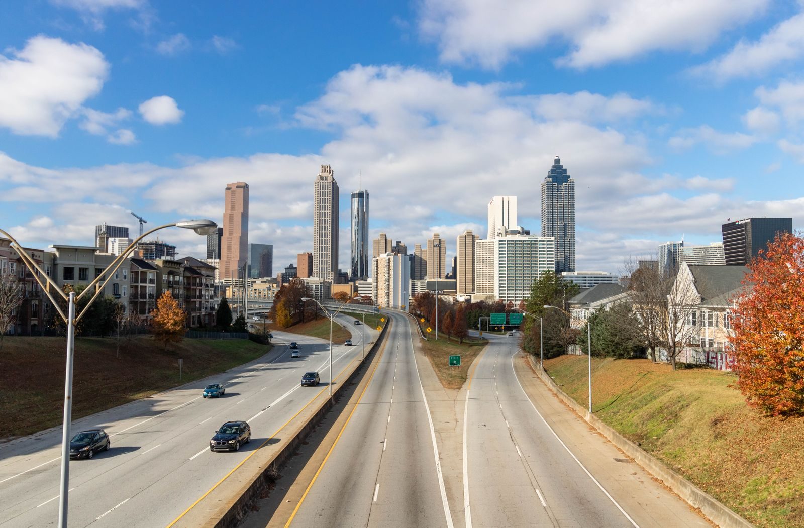 The Atlanta skyline on a sunny day seen down a highway leading into downtown