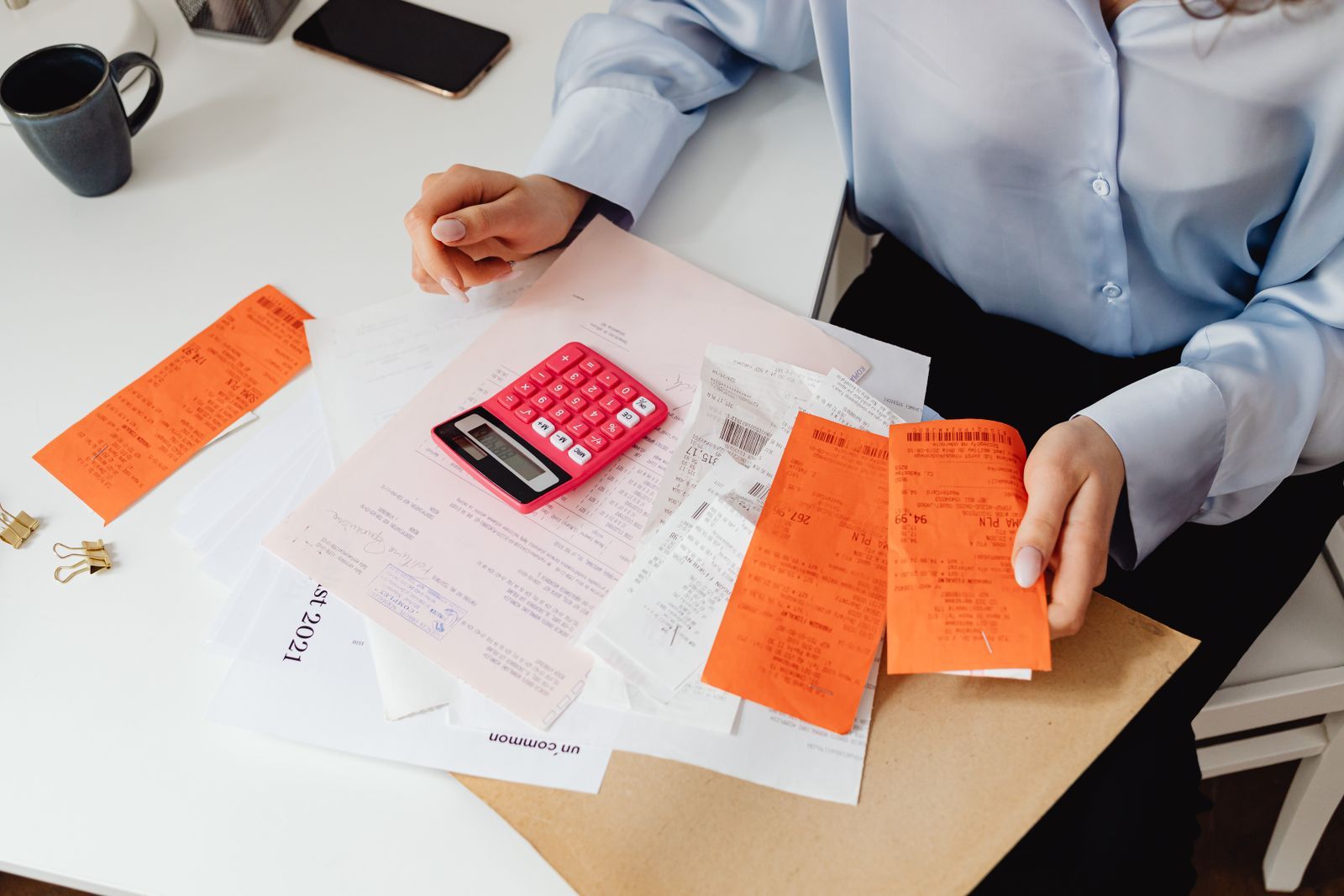 Receipts and a calculator spread on a desk