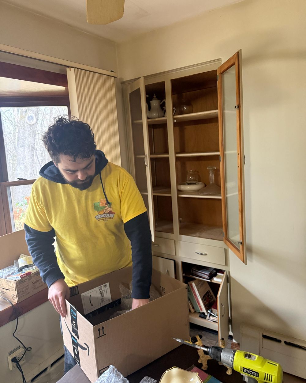 Jacob packing a carton on a job